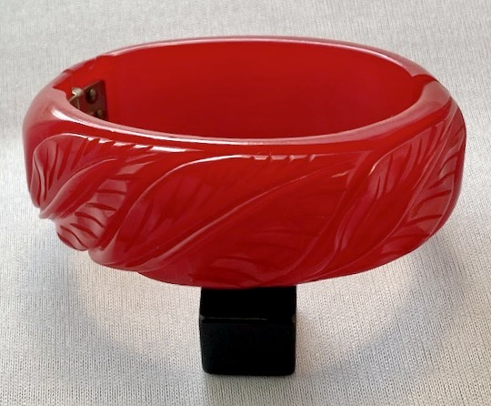 BB172 hinged leaf carved red jello bakelite bracelet